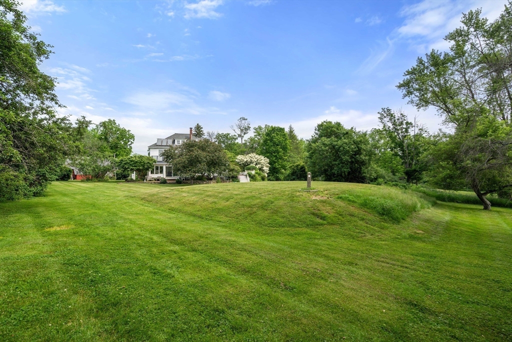 142 Pelham Island Road Wayland, MA 01778 - Photo 8 of 39 a view of a green field with wooden fence