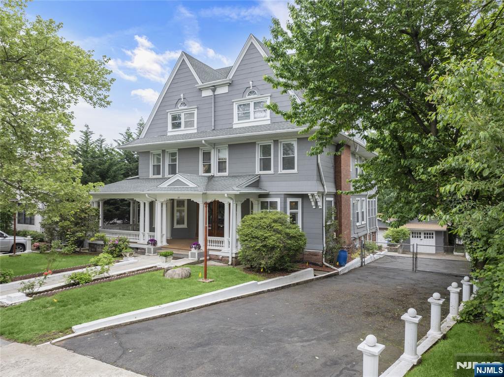 119 High Street Passaic, NJ 07055 - Photo 1 of 38 a front view of a house with a yard and potted plants