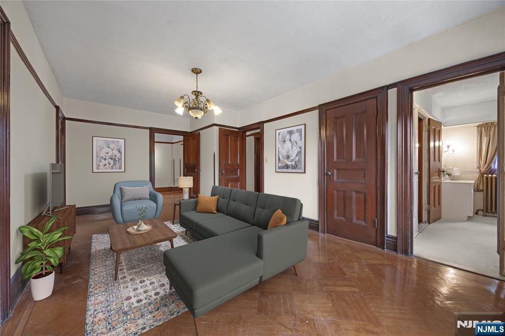 119 High Street Passaic, NJ 07055 - Photo 16 of 38 a living room with furniture and a chandelier