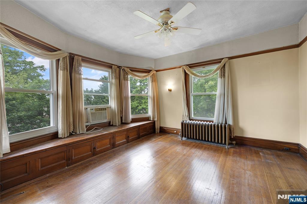 119 High Street Passaic, NJ 07055 - Photo 19 of 38 a view of an empty room with wooden floor and a window