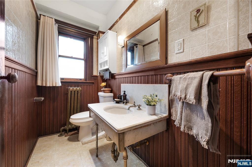 119 High Street Passaic, NJ 07055 - Photo 21 of 38 a bathroom with a sink toilet and window