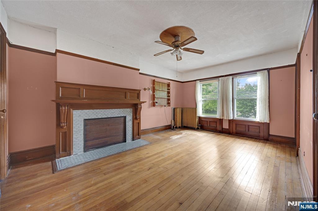 119 High Street Passaic, NJ 07055 - Photo 22 of 38 a view of empty room with wooden floor and fireplace