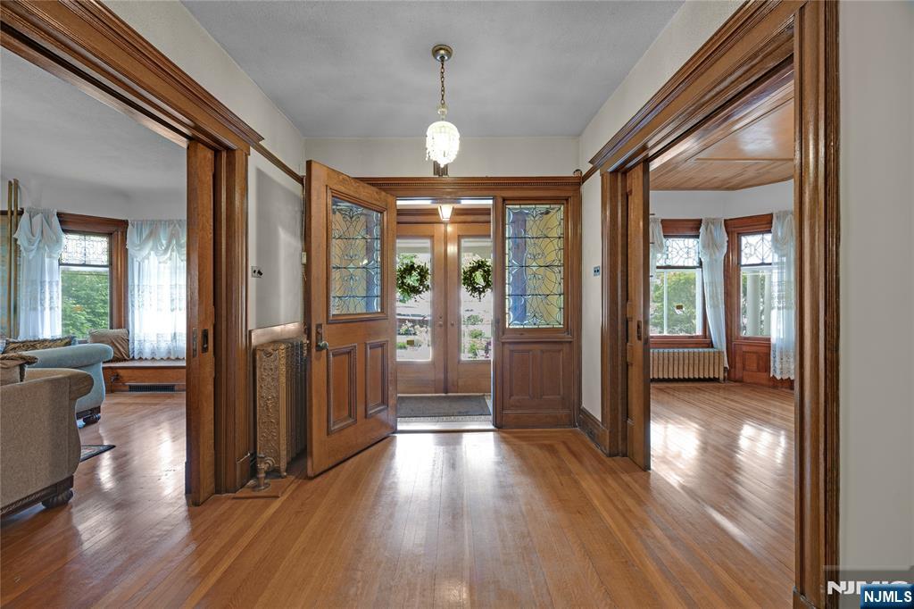 119 High Street Passaic, NJ 07055 - Photo 3 of 38 a view of a hallway with wooden floor and windows