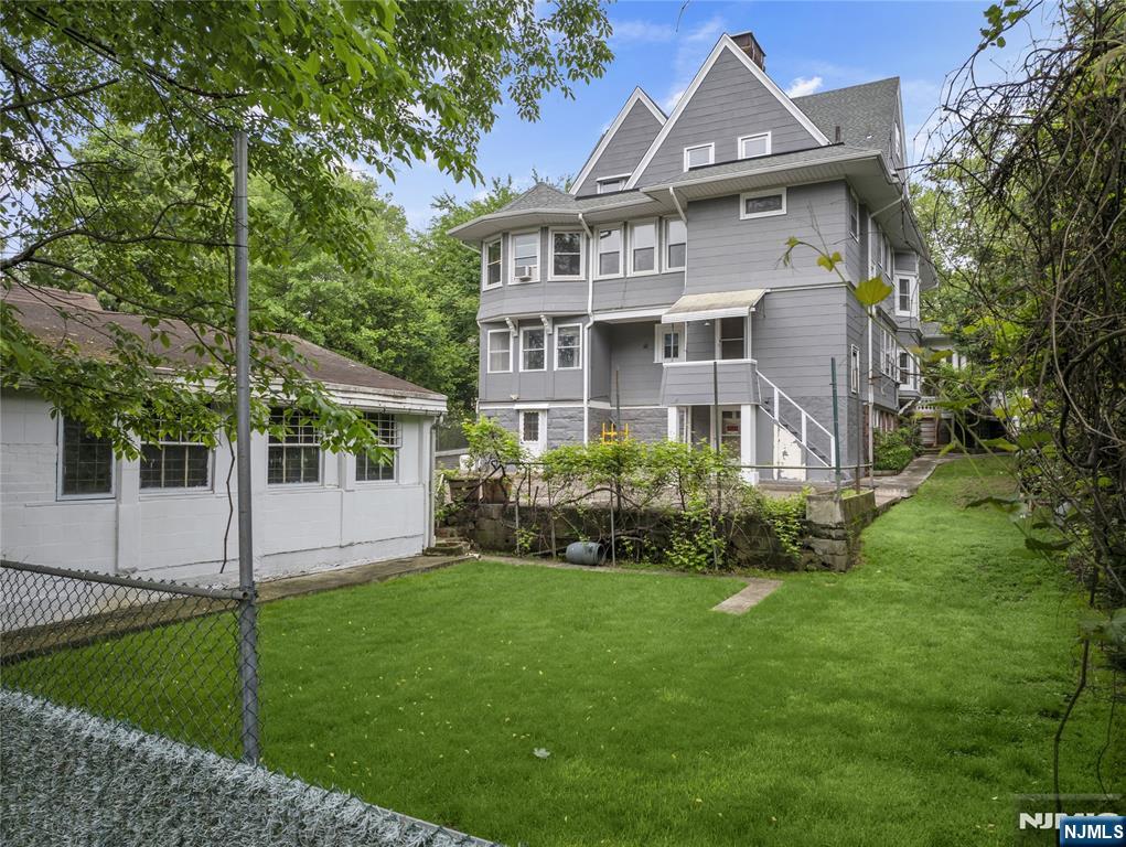 119 High Street Passaic, NJ 07055 - Photo 36 of 38 a front view of a house with a yard