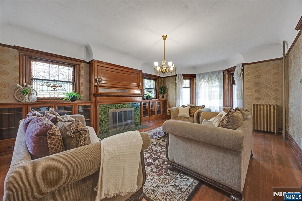 119 High Street Passaic, NJ 07055 - Photo 6 of 38 a living room with furniture chandelier and a fireplace