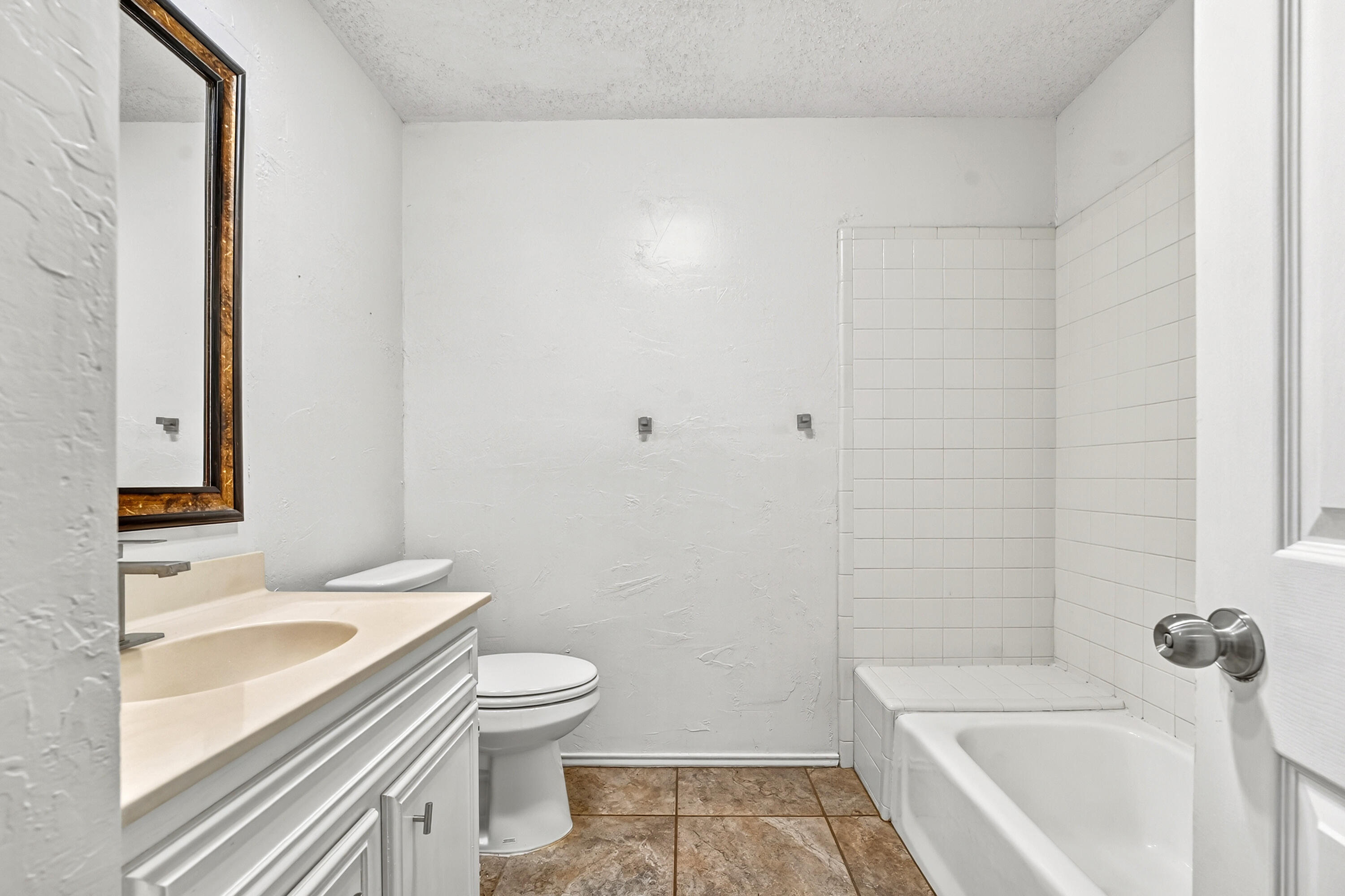 5221 84th Street Lubbock, TX 79424 - Photo 23 of 26 a bathroom with a sink a toilet and shower