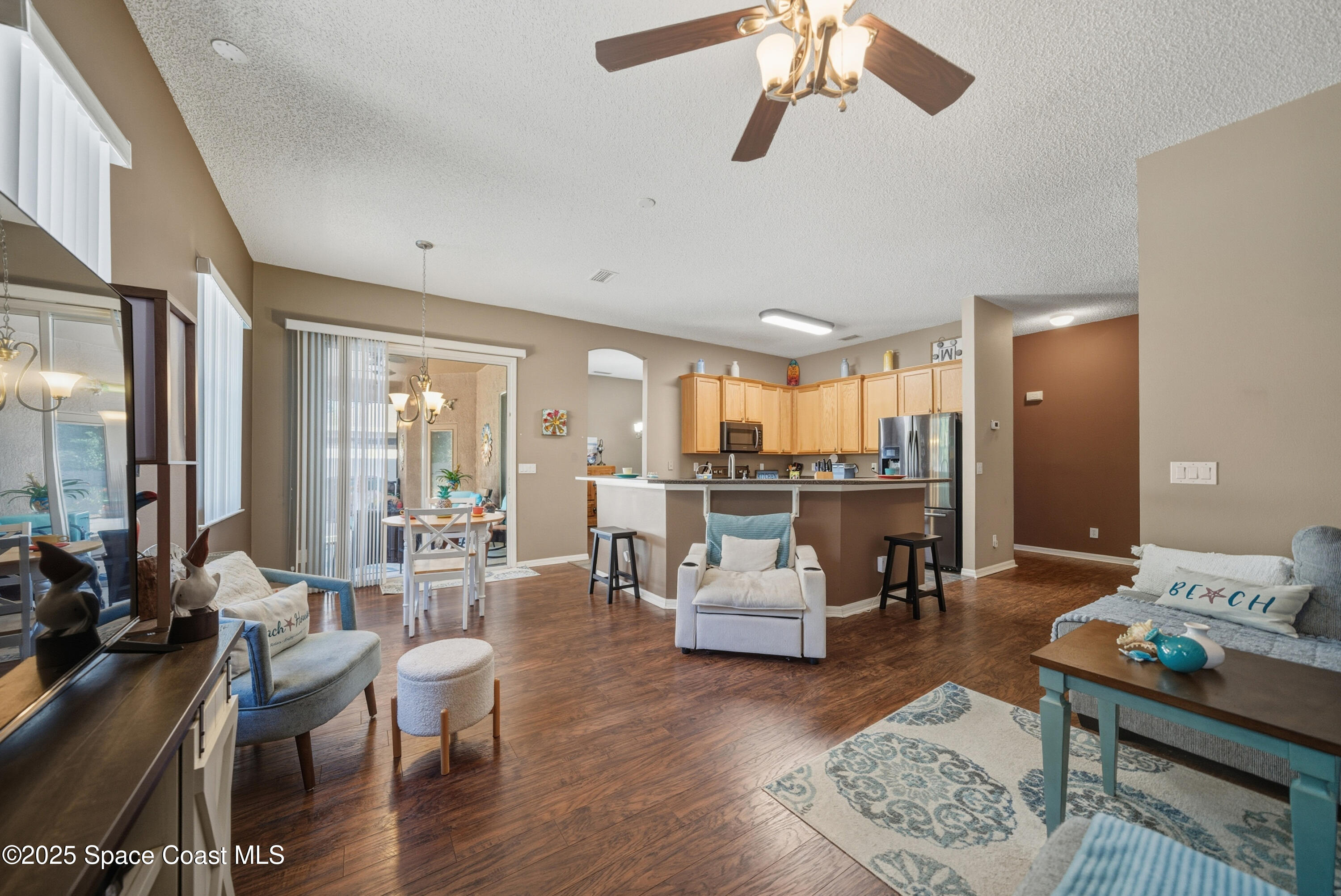 7368 Crepe Myrtle Court Cocoa, FL 32927 - Photo 16 of 50 a living room with lots of furniture and view of kitchen