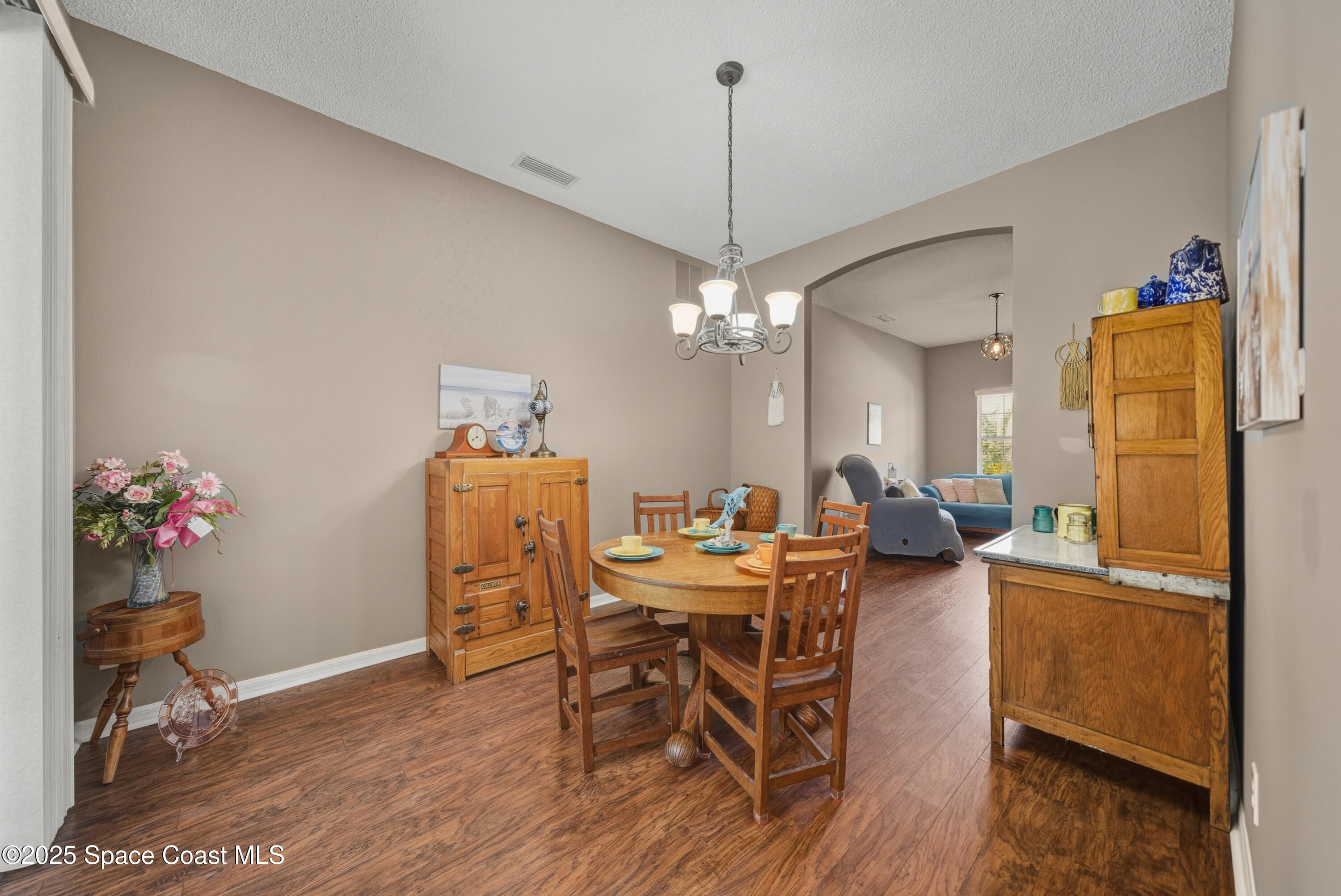7368 Crepe Myrtle Court Cocoa, FL 32927 - Photo 17 of 50 a view of a dining room with furniture and wooden floor