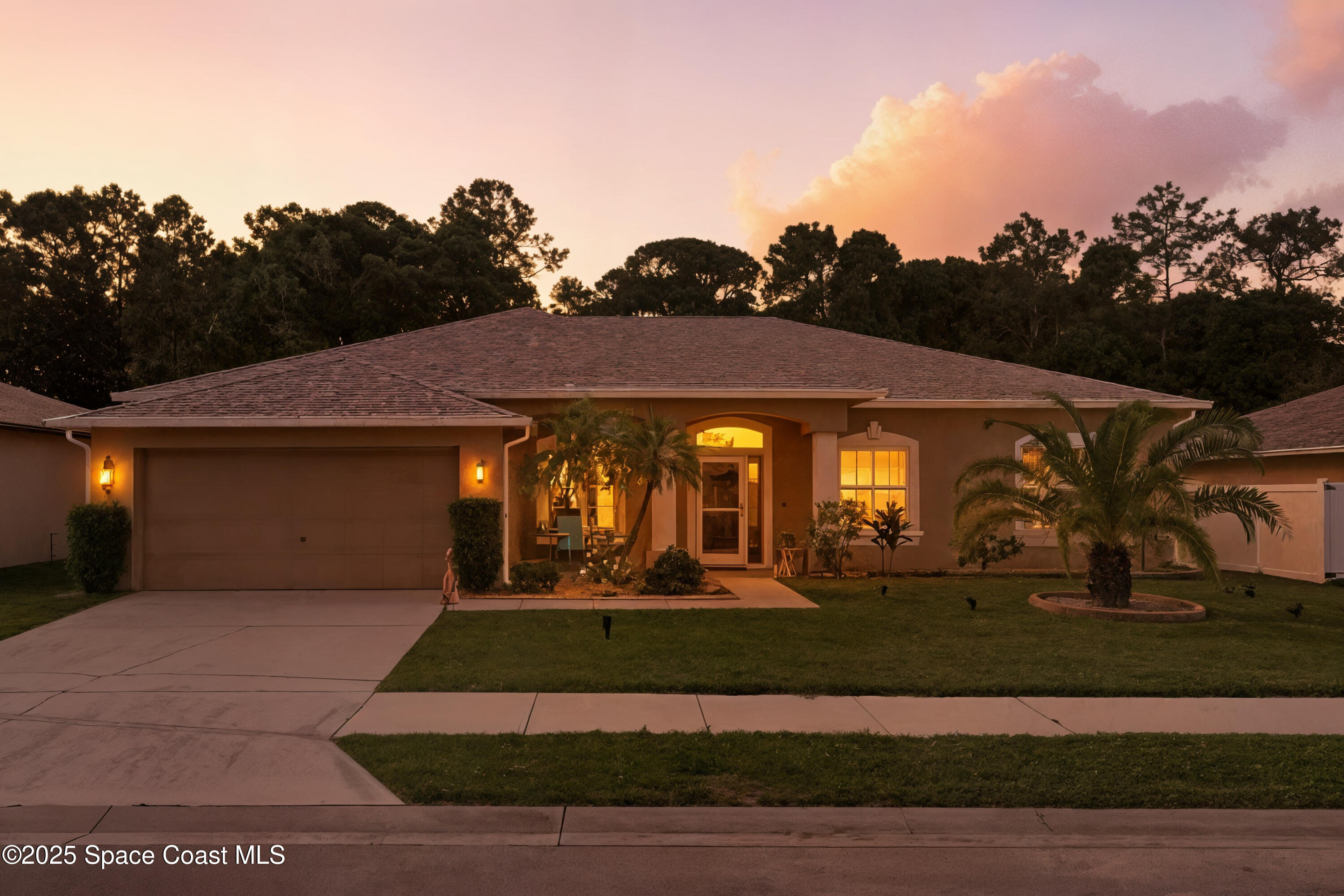 7368 Crepe Myrtle Court Cocoa, FL 32927 - Photo 2 of 50 a front view of a house with garden