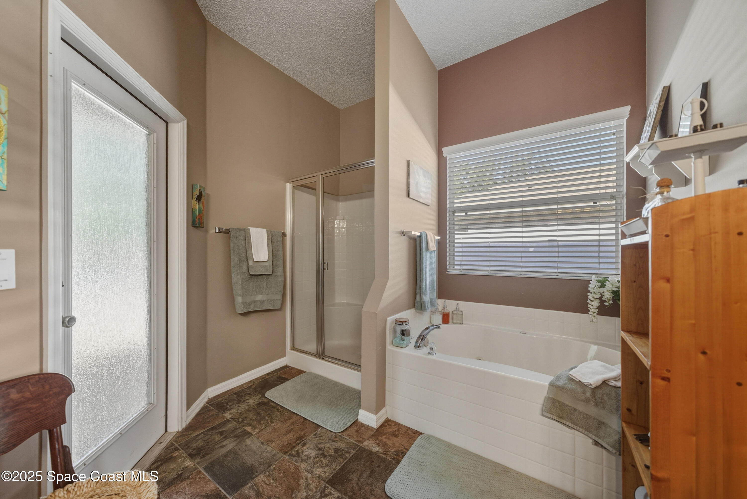 7368 Crepe Myrtle Court Cocoa, FL 32927 - Photo 23 of 50 a bathroom with a bathtub and shower
