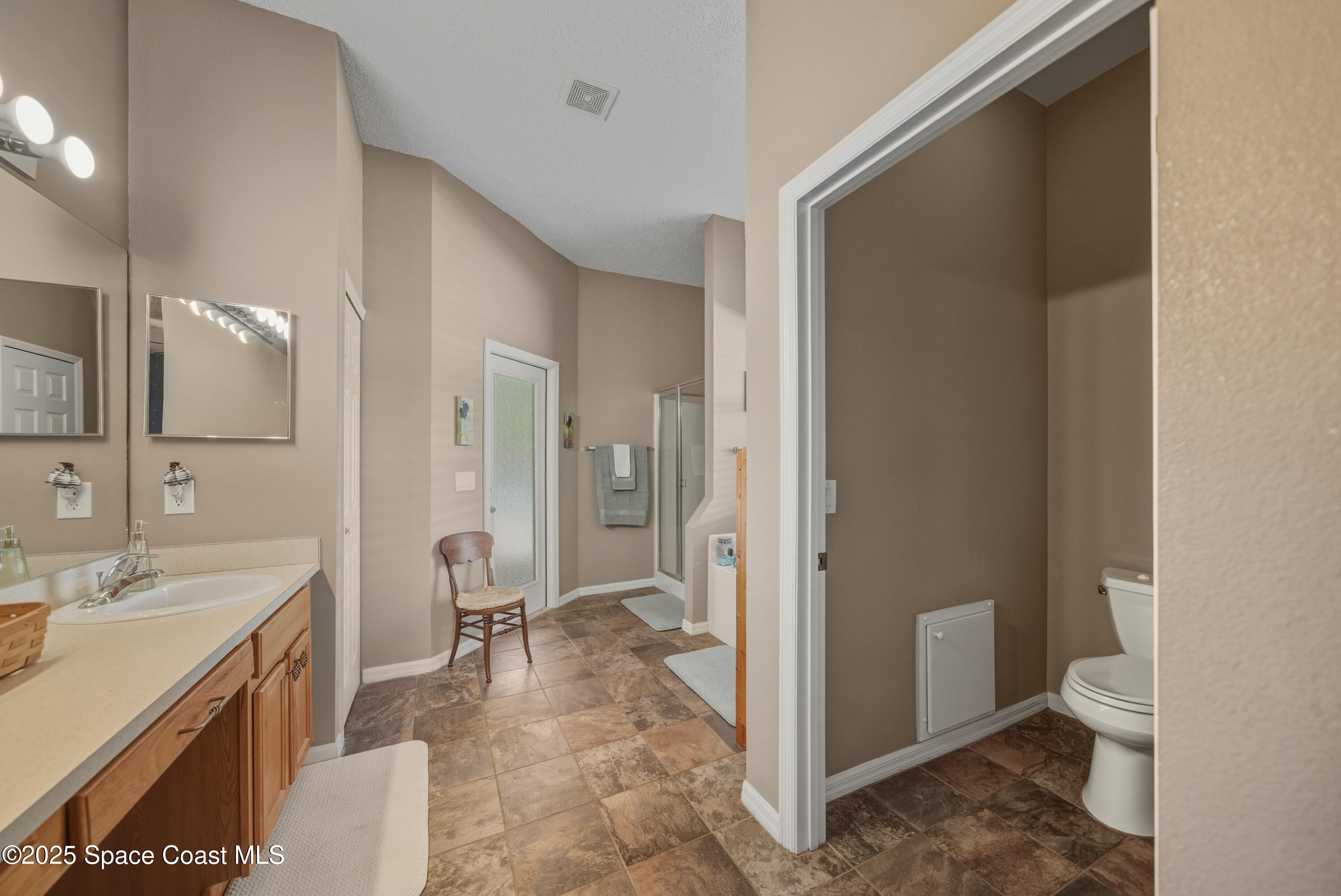 7368 Crepe Myrtle Court Cocoa, FL 32927 - Photo 24 of 50 a bathroom with a sink a toilet and shower