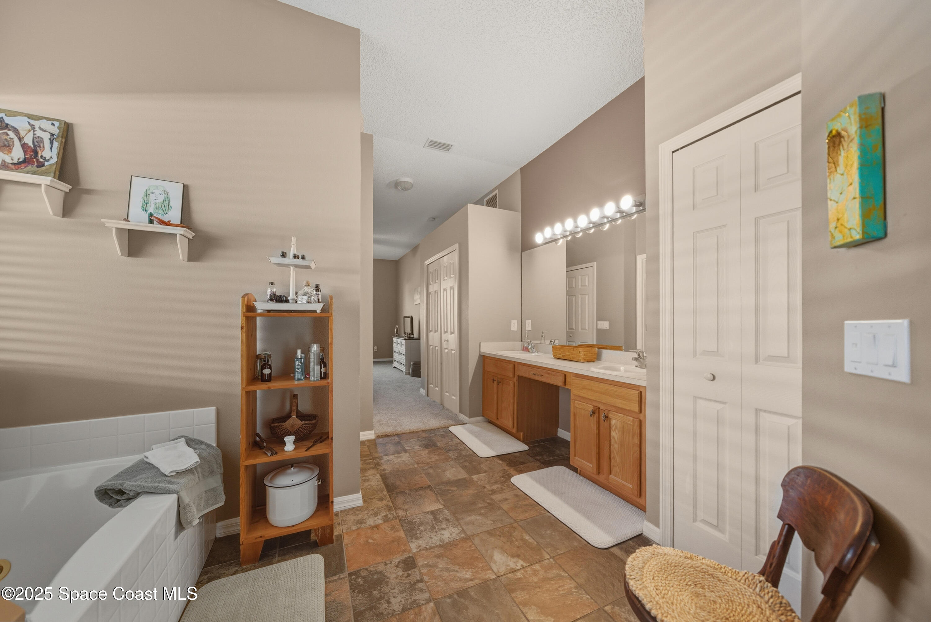 7368 Crepe Myrtle Court Cocoa, FL 32927 - Photo 25 of 50 a large bathroom with a tub and shower