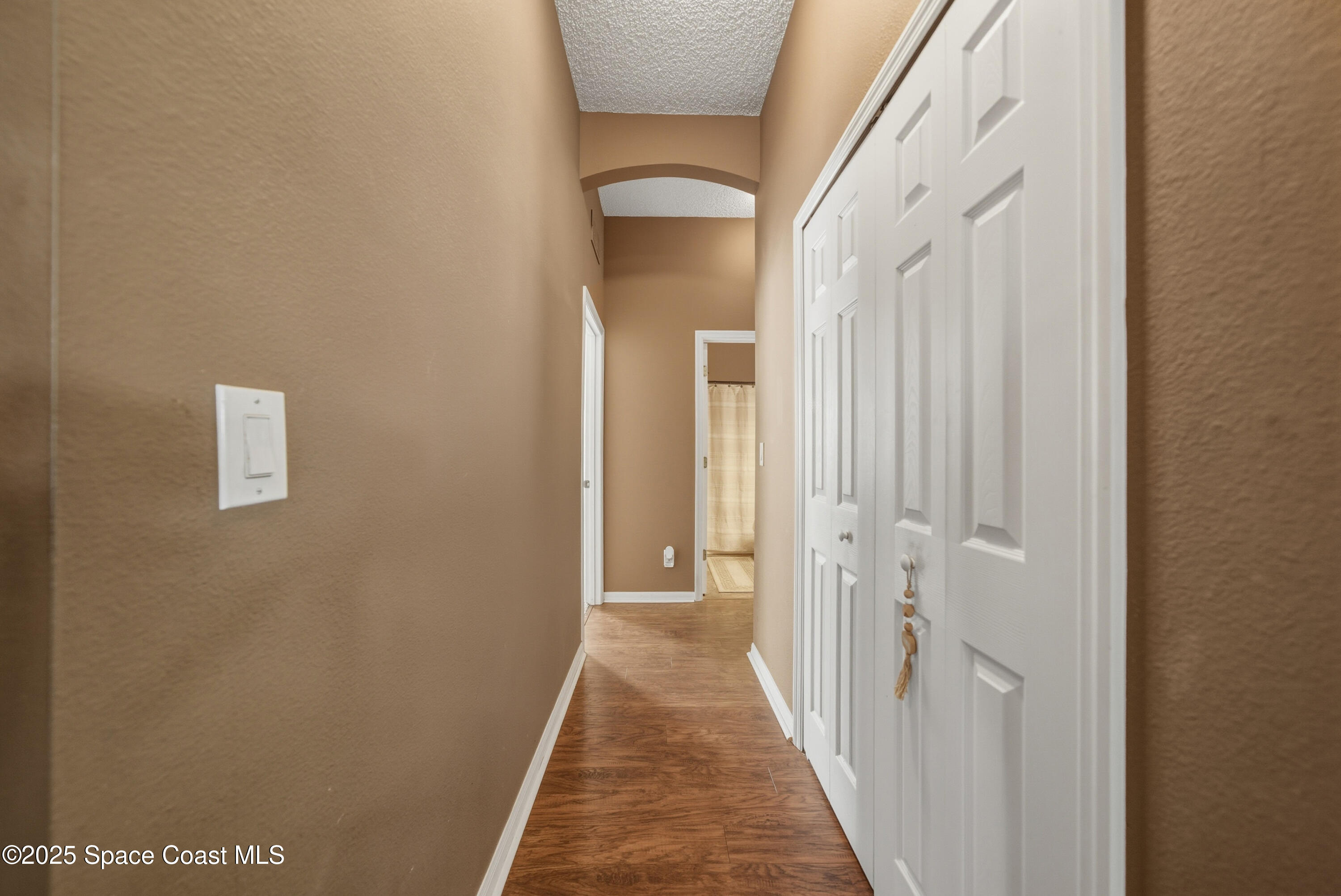 7368 Crepe Myrtle Court Cocoa, FL 32927 - Photo 27 of 50 a view of a hallway with wooden floor and a bathroom