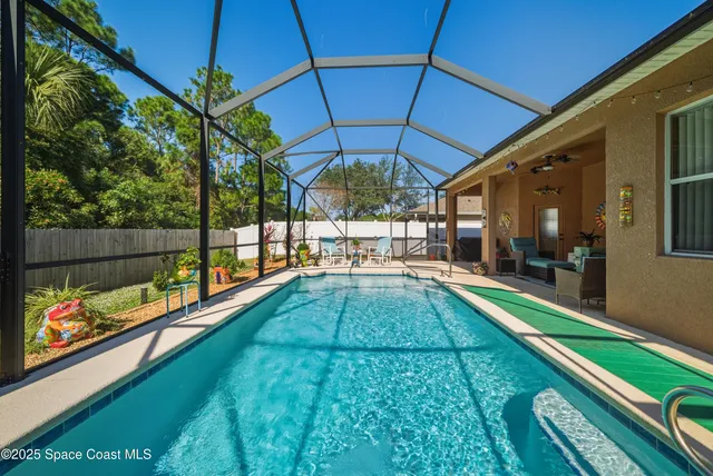 a view of a house with backyard porch and sitting area