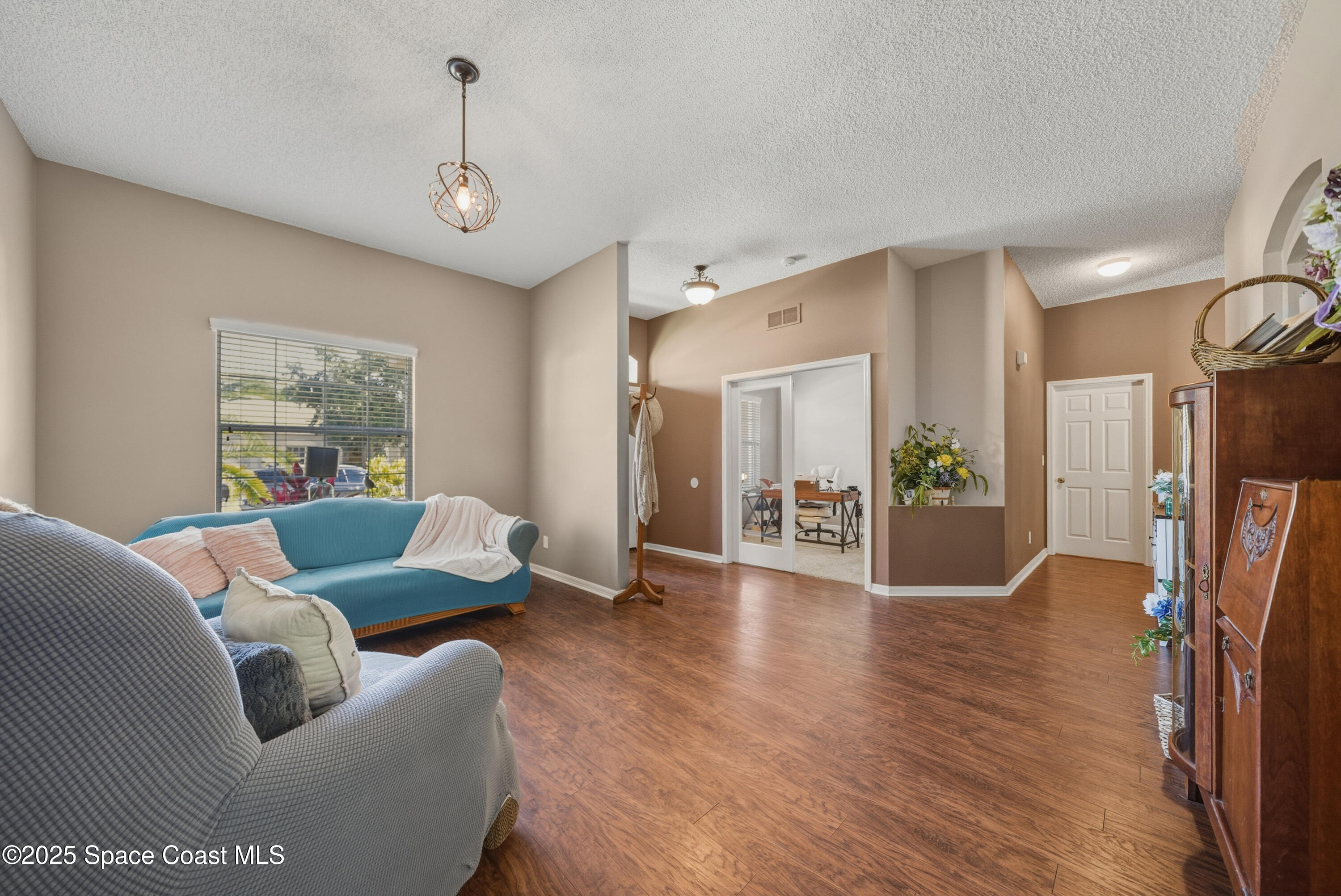 7368 Crepe Myrtle Court Cocoa, FL 32927 - Photo 6 of 50 a living room with furniture and a wooden floor