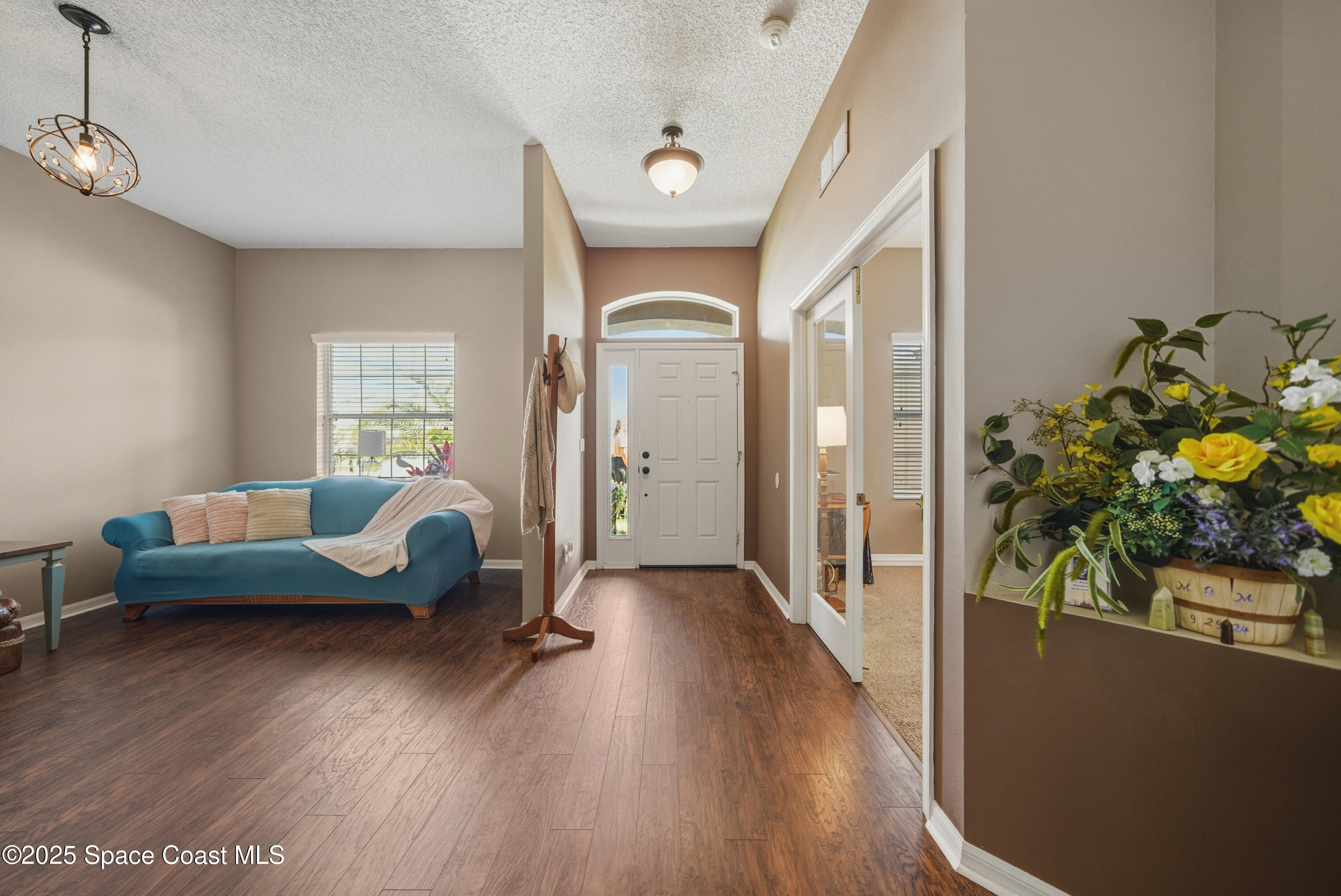 7368 Crepe Myrtle Court Cocoa, FL 32927 - Photo 7 of 50 a living room with furniture and a wooden floor