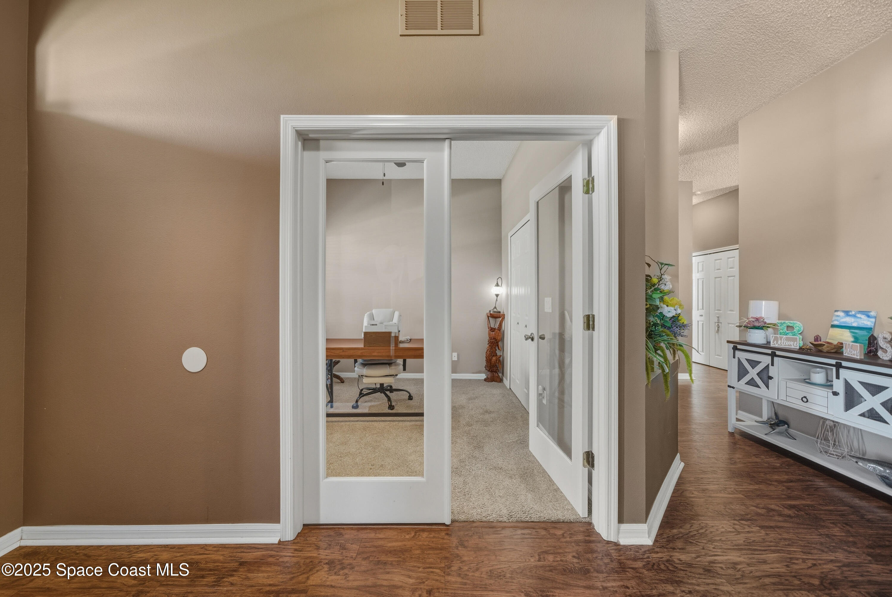 7368 Crepe Myrtle Court Cocoa, FL 32927 - Photo 8 of 50 a view of a bedroom from a hallway