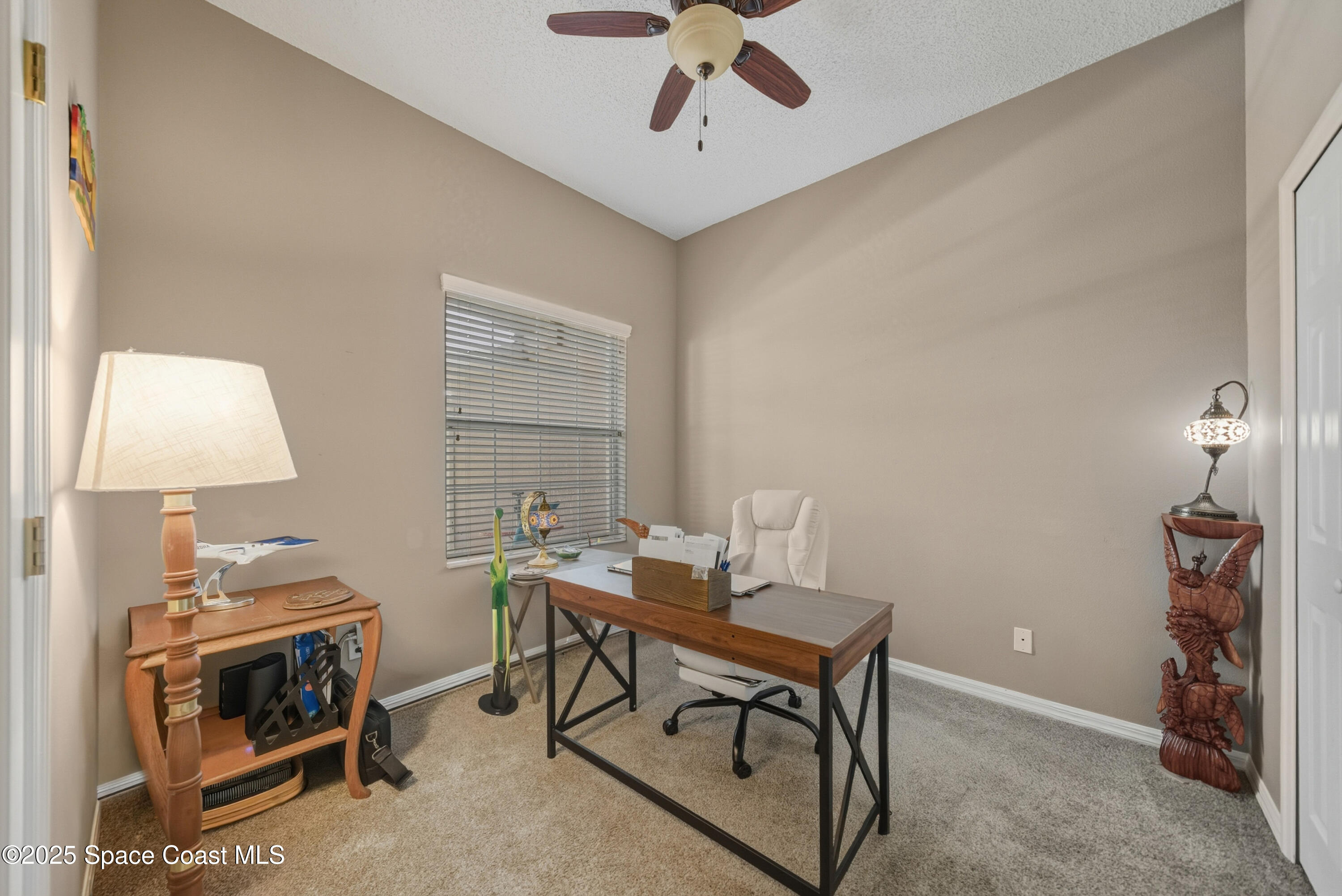 7368 Crepe Myrtle Court Cocoa, FL 32927 - Photo 9 of 50 a workspace with furniture and lamp