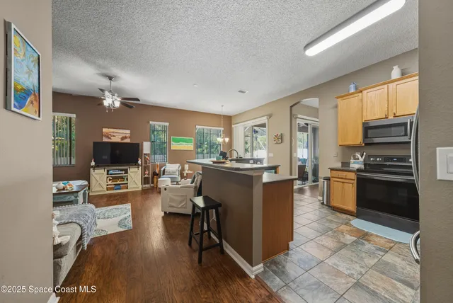 a kitchen with stainless steel appliances granite countertop a refrigerator stove and oven