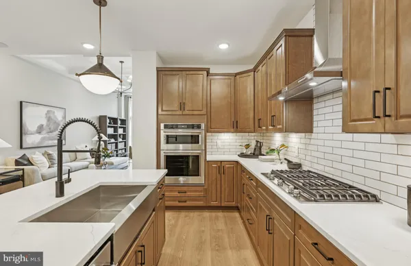 a kitchen with a stove a sink and a refrigerator