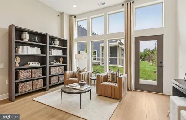 a living room with furniture and a book shelf