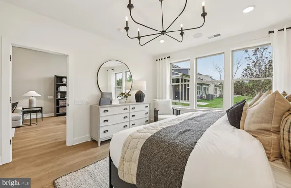 a bedroom with a bed window and a table