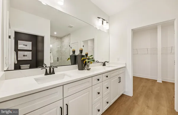 a bathroom with a double vanity sink and mirror