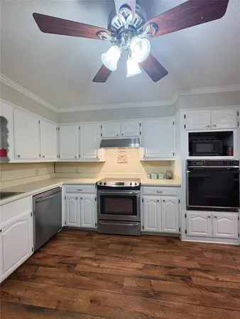 a kitchen with stainless steel appliances a stove sink and microwave