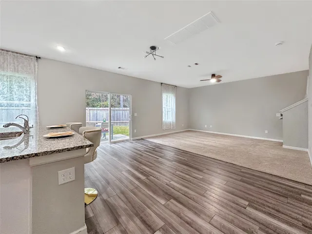 a open kitchen with stainless steel appliances granite countertop a sink stove and wooden floor