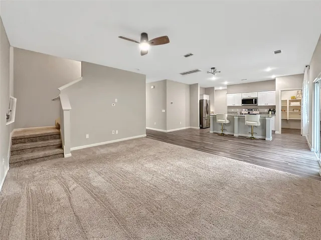 a view of a livingroom with furniture and a ceiling fan
