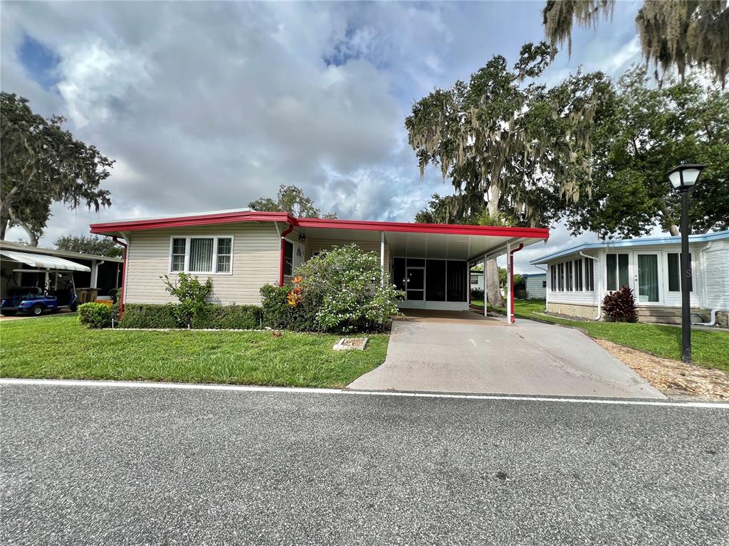 a front view of a house with a yard and a garage