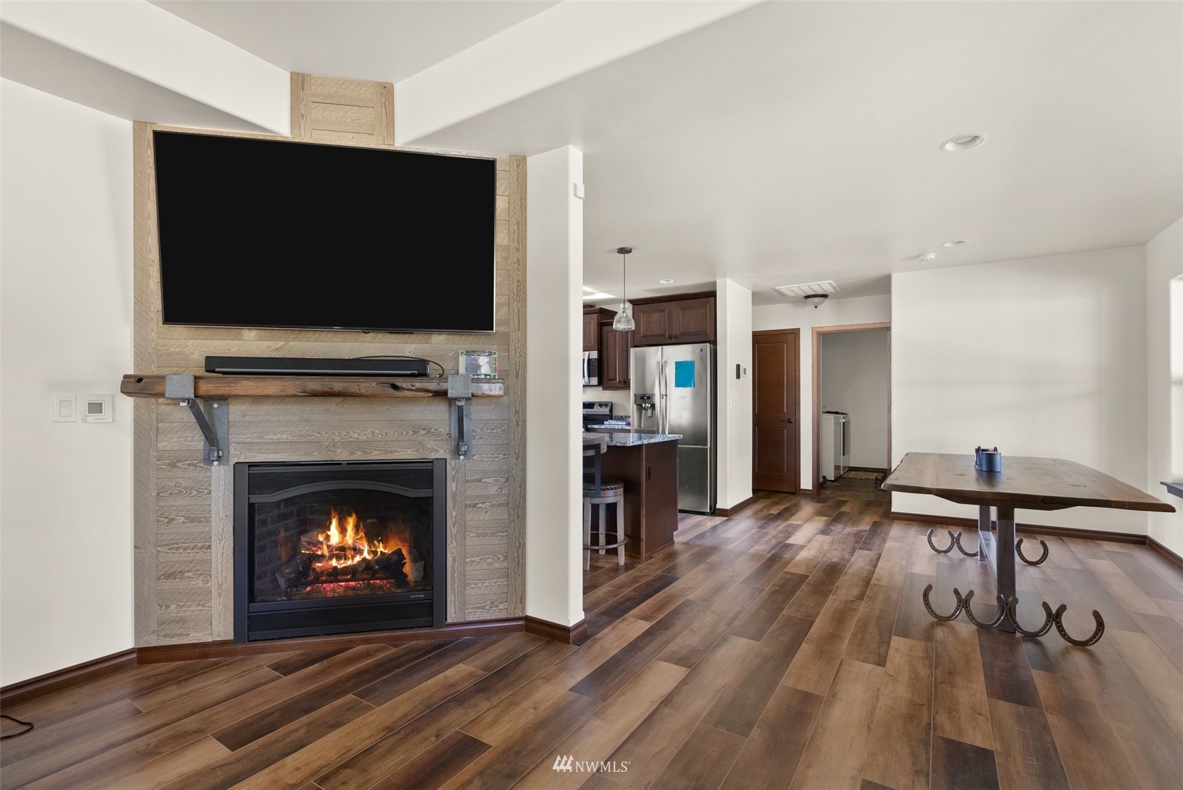 16622 Leitner Road Southwest Rochester, WA 98579 - Photo 11 of 29 a living room with a fireplace and a flat screen tv