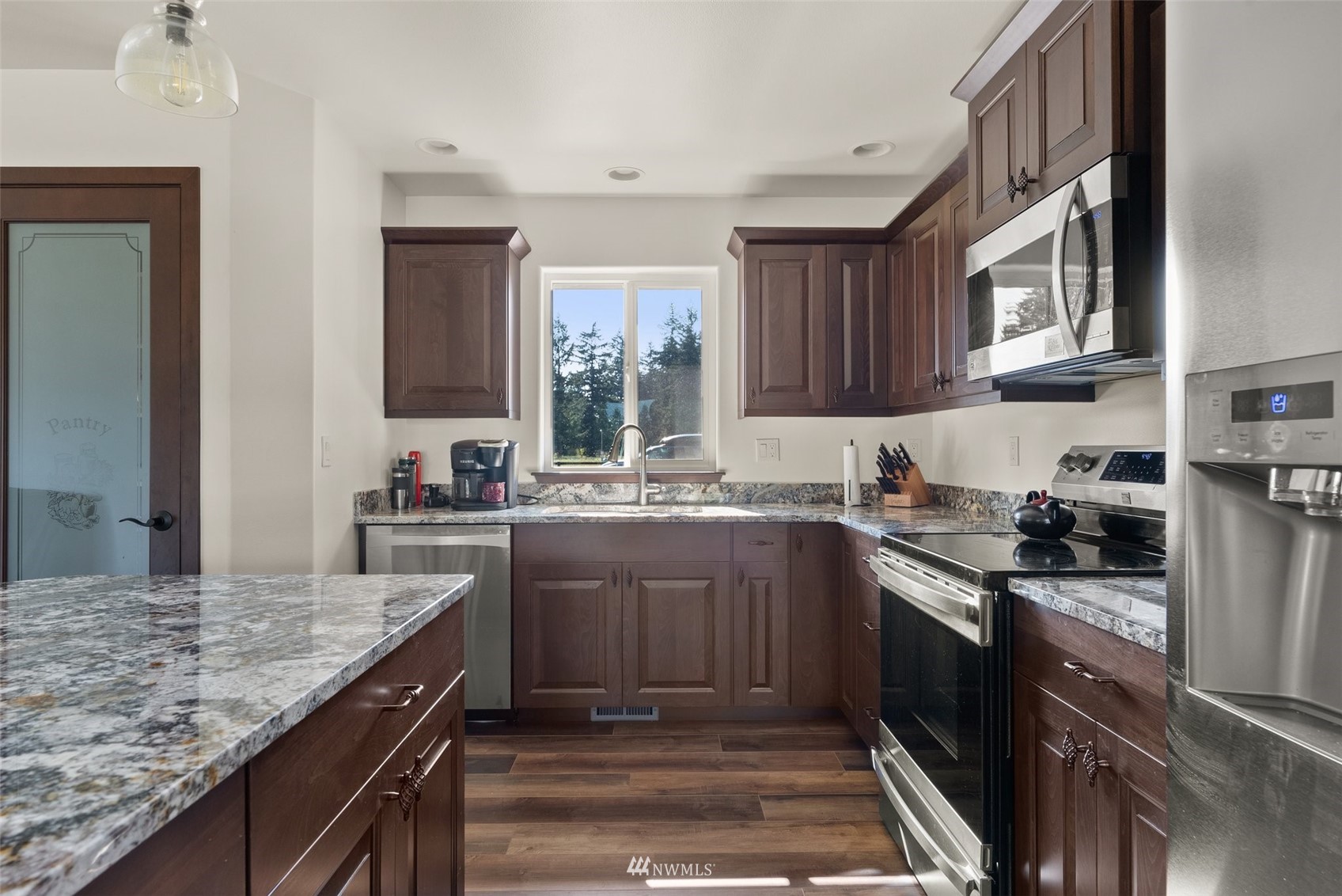 16622 Leitner Road Southwest Rochester, WA 98579 - Photo 15 of 29 a kitchen with stainless steel appliances granite countertop a stove and a sink