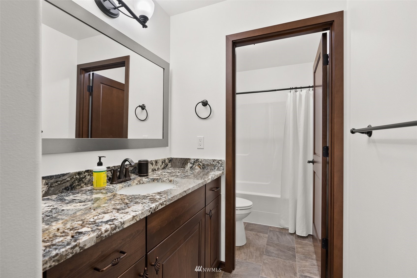 16622 Leitner Road Southwest Rochester, WA 98579 - Photo 17 of 29 a bathroom with a granite countertop sink and a mirror