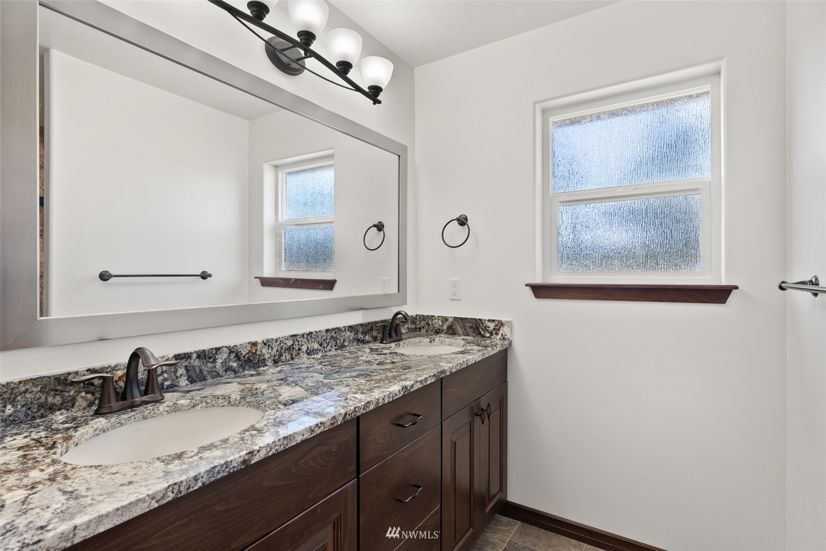 16622 Leitner Road Southwest Rochester, WA 98579 - Photo 19 of 29 a bathroom with a granite countertop sink and a mirror