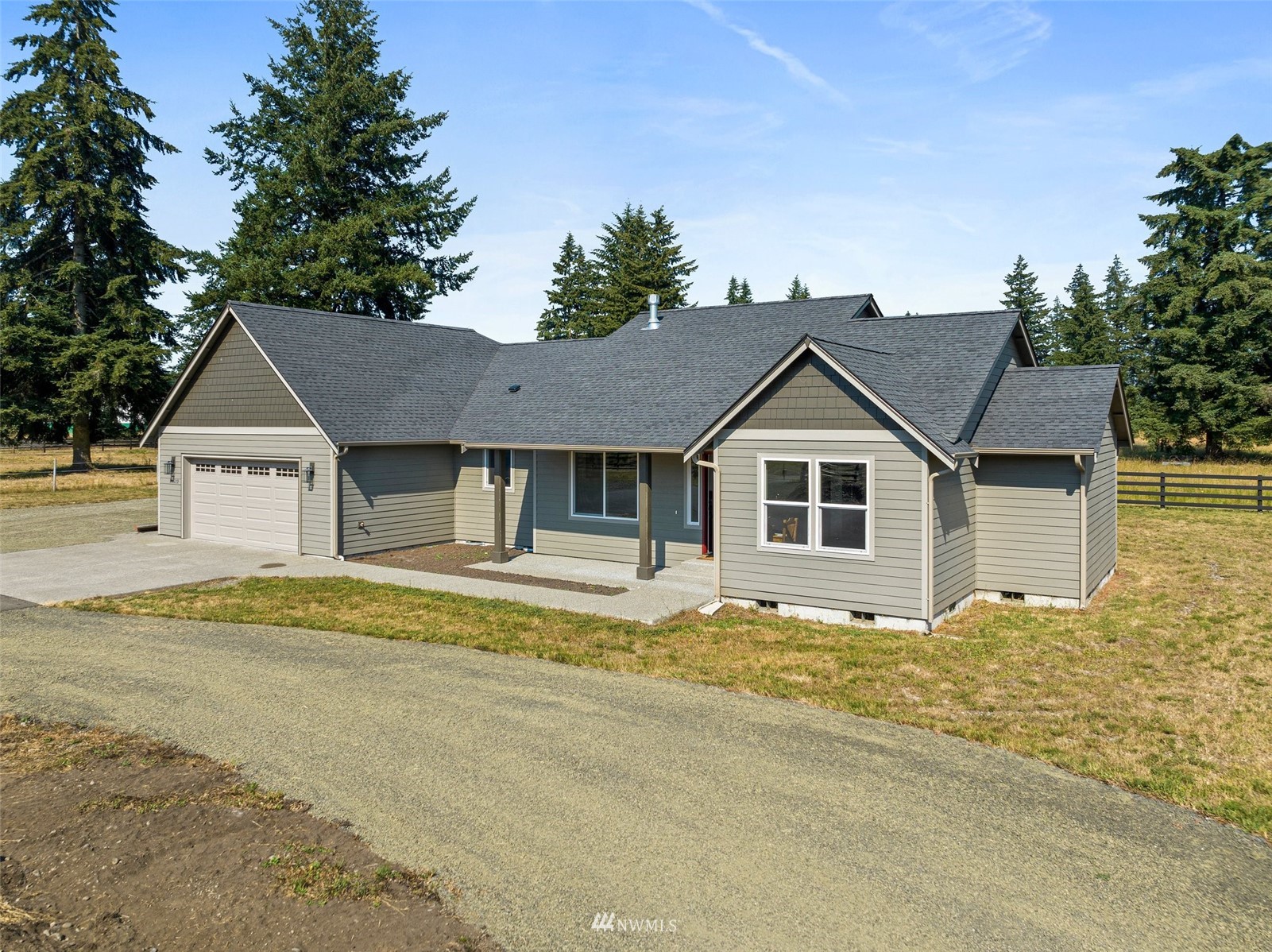 16622 Leitner Road Southwest Rochester, WA 98579 - Photo 4 of 29 a front view of a house with a yard and garage