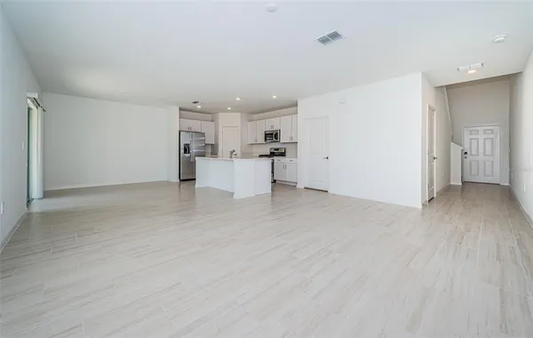 a view of a kitchen with wooden floor