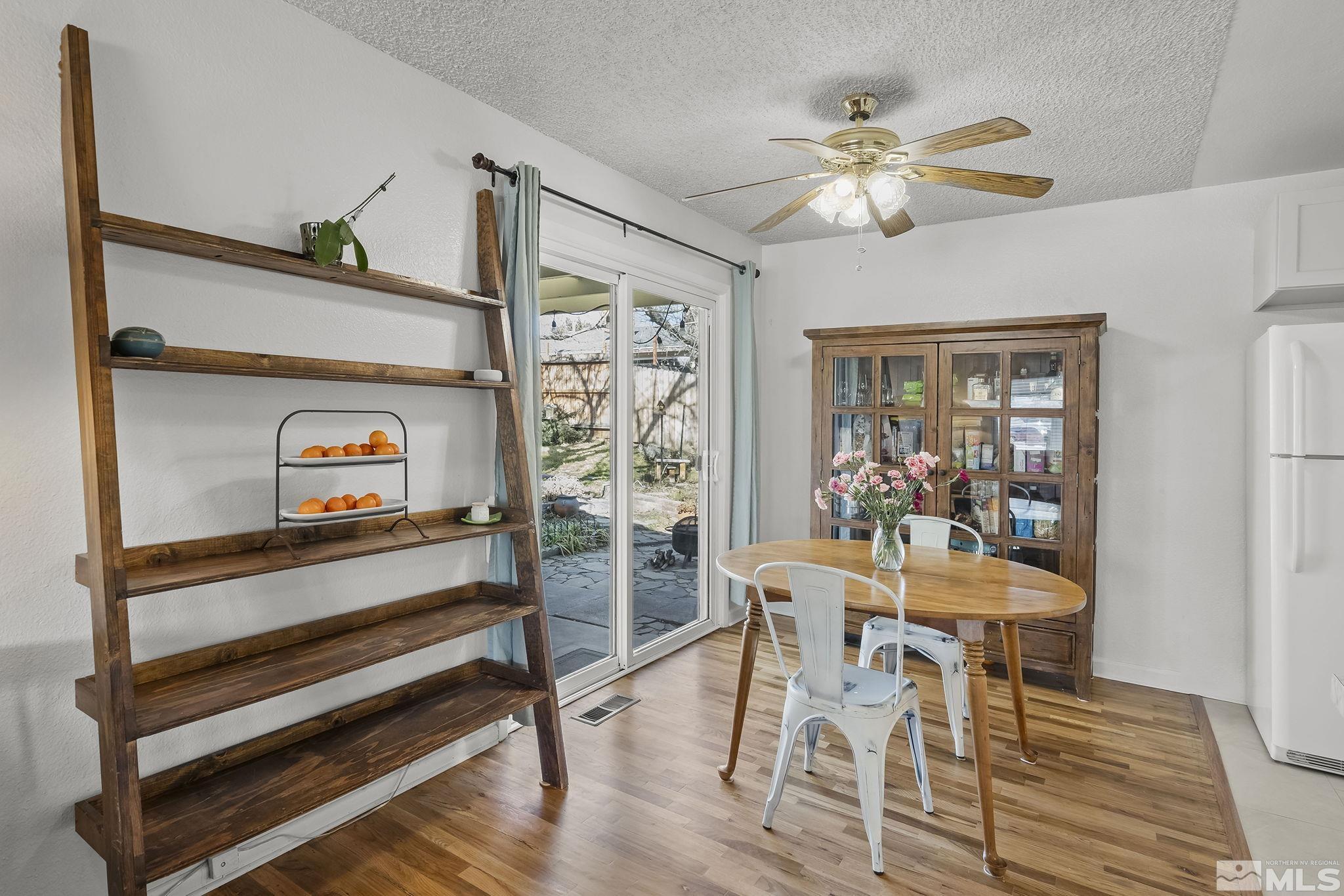 1370 Beldon Way Reno, NV 89503 - Photo 7 of 23 a dining room with furniture a rug and a chandelier