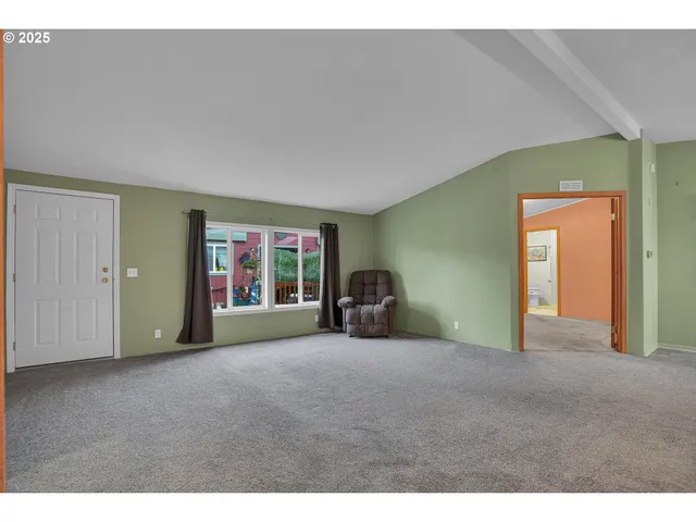 a view of a livingroom with furniture and window