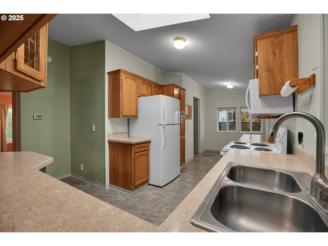 a kitchen with refrigerator and stove