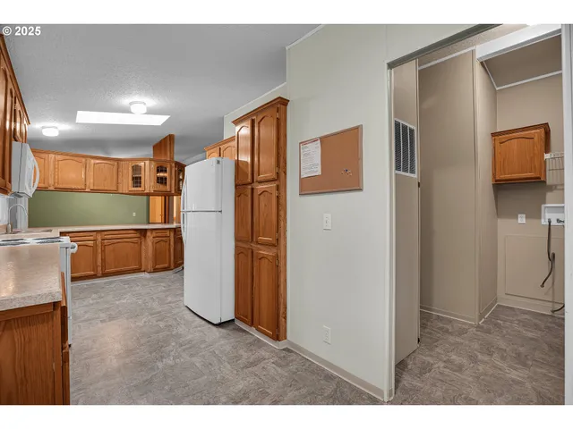 a open kitchen with a refrigerator and a sink