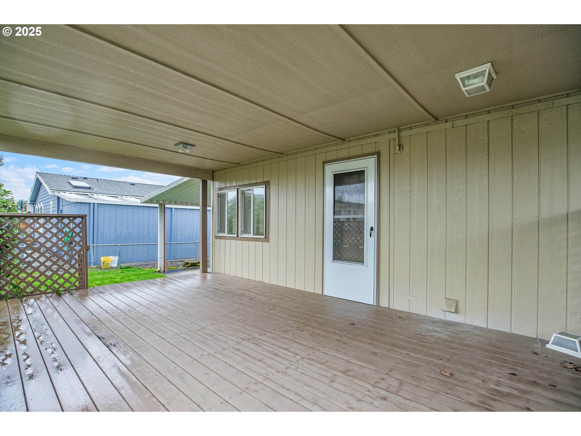 51459 Westlake Drive, Unit 102 Scappoose, OR 97056 - Photo 4 of 40 a view of an empty room with wooden floor and a window