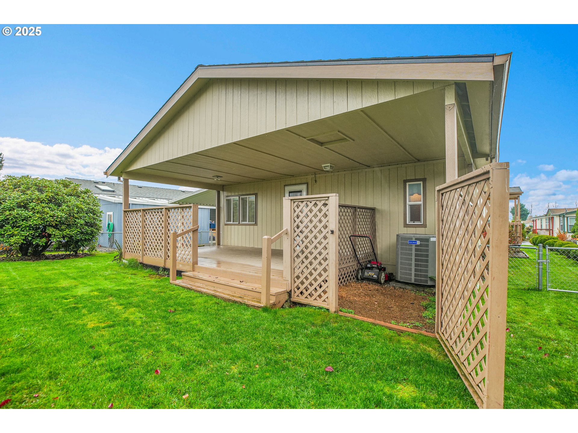 51459 Westlake Drive, Unit 102 Scappoose, OR 97056 - Photo 5 of 40 a view of a backyard with plants and a patio