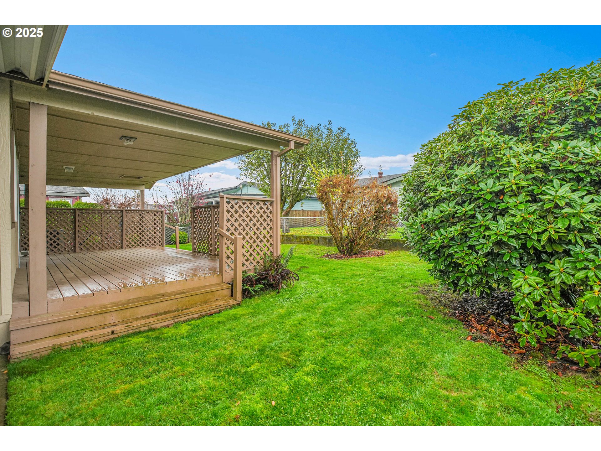 51459 Westlake Drive, Unit 102 Scappoose, OR 97056 - Photo 9 of 40 a view of backyard with garden and deck