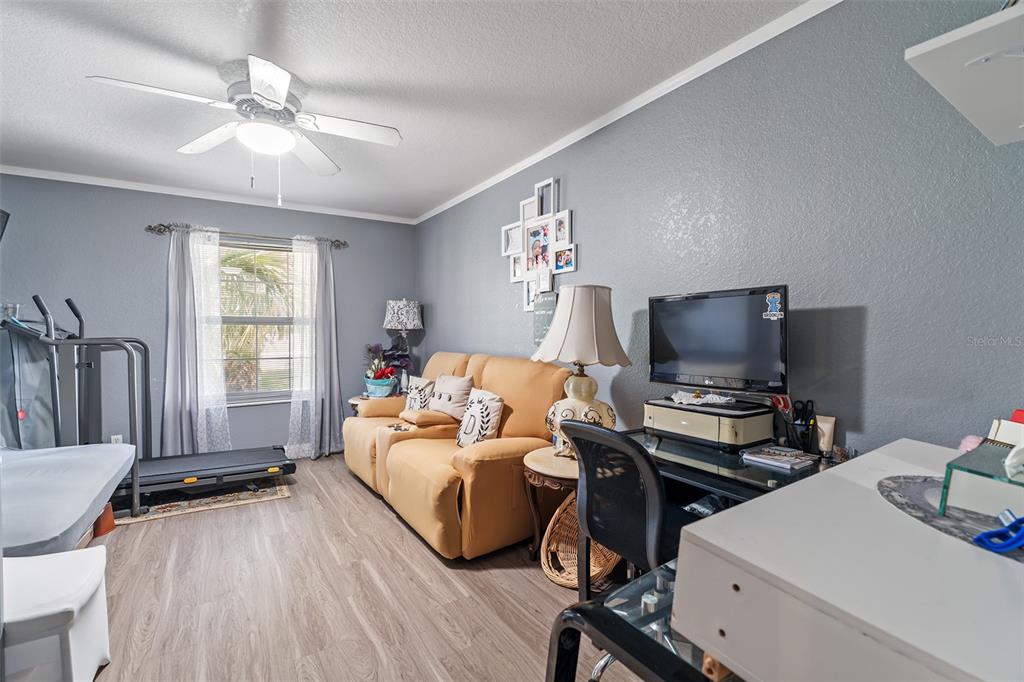 2830 Horton Road Kissimmee, FL 34744 - Photo 17 of 35 a bedroom with a bed and a flat screen tv