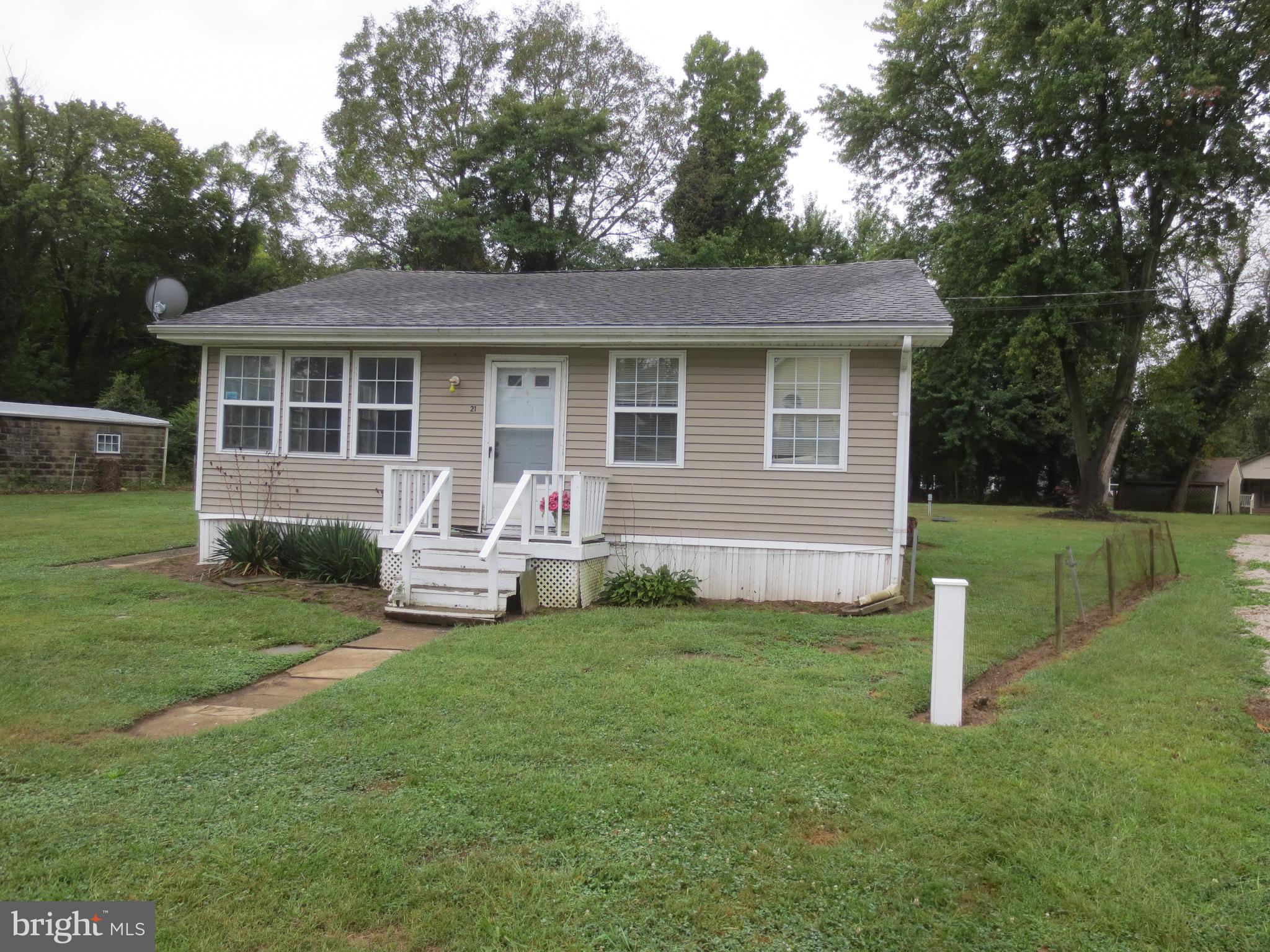 a view of a house with a yard and sitting area