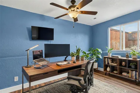 a view of a workspace with a table and a television