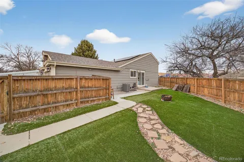a view of a house with a yard and sitting area