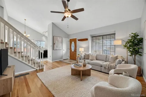 a living room with furniture and a chandelier