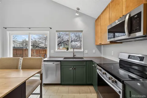 a kitchen with stainless steel appliances granite countertop a sink and a stove top oven with granite countertops